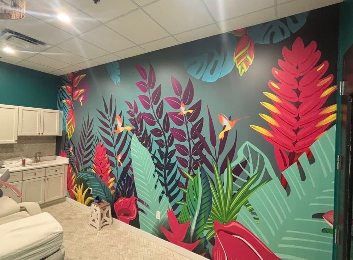 Tropical leaf mural wallpaper installed on a commercial spa accent wall