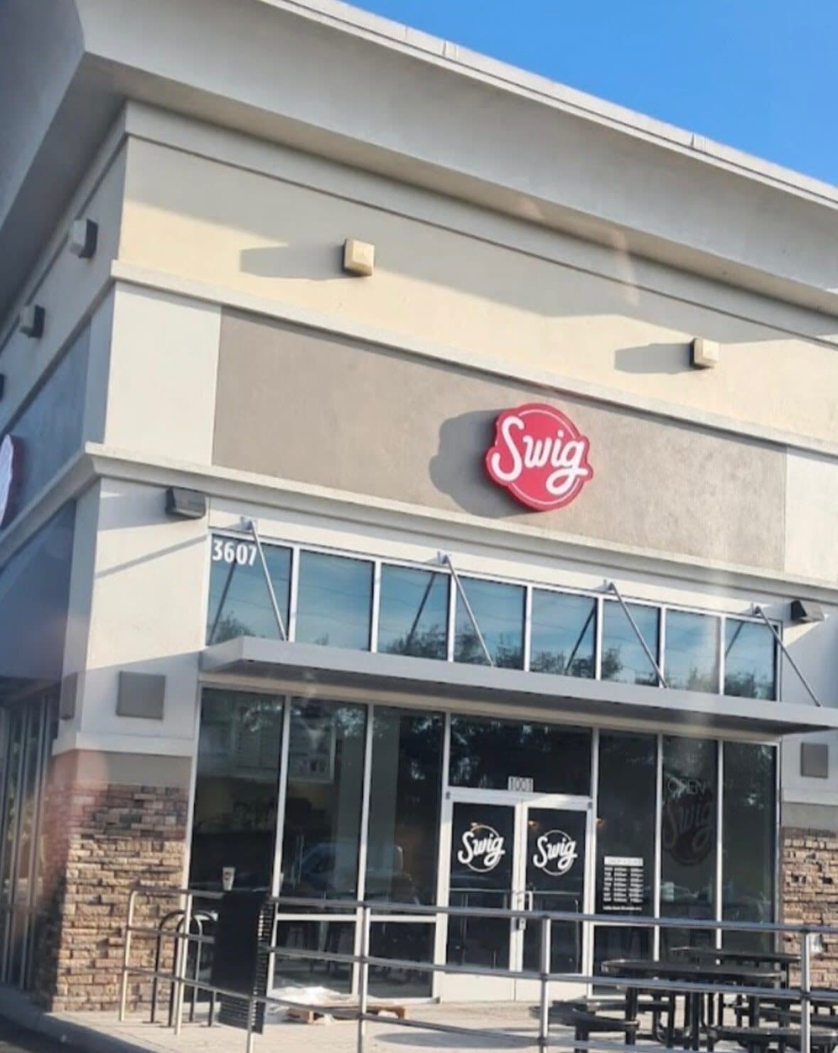 Commercial storefront exterior finished in neutral tones for a drive-up beverage shop