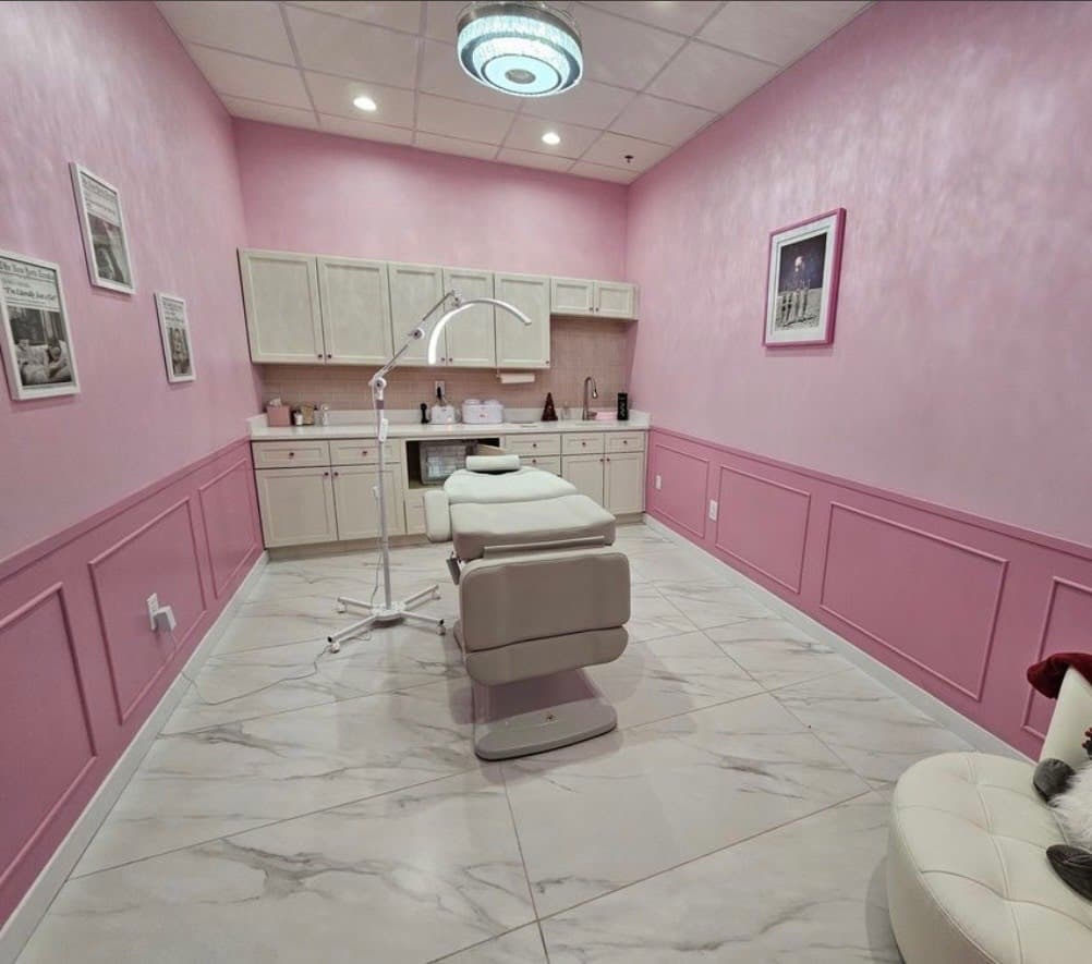 Commercial spa treatment room finished in pink with painted wainscoting and cabinetry