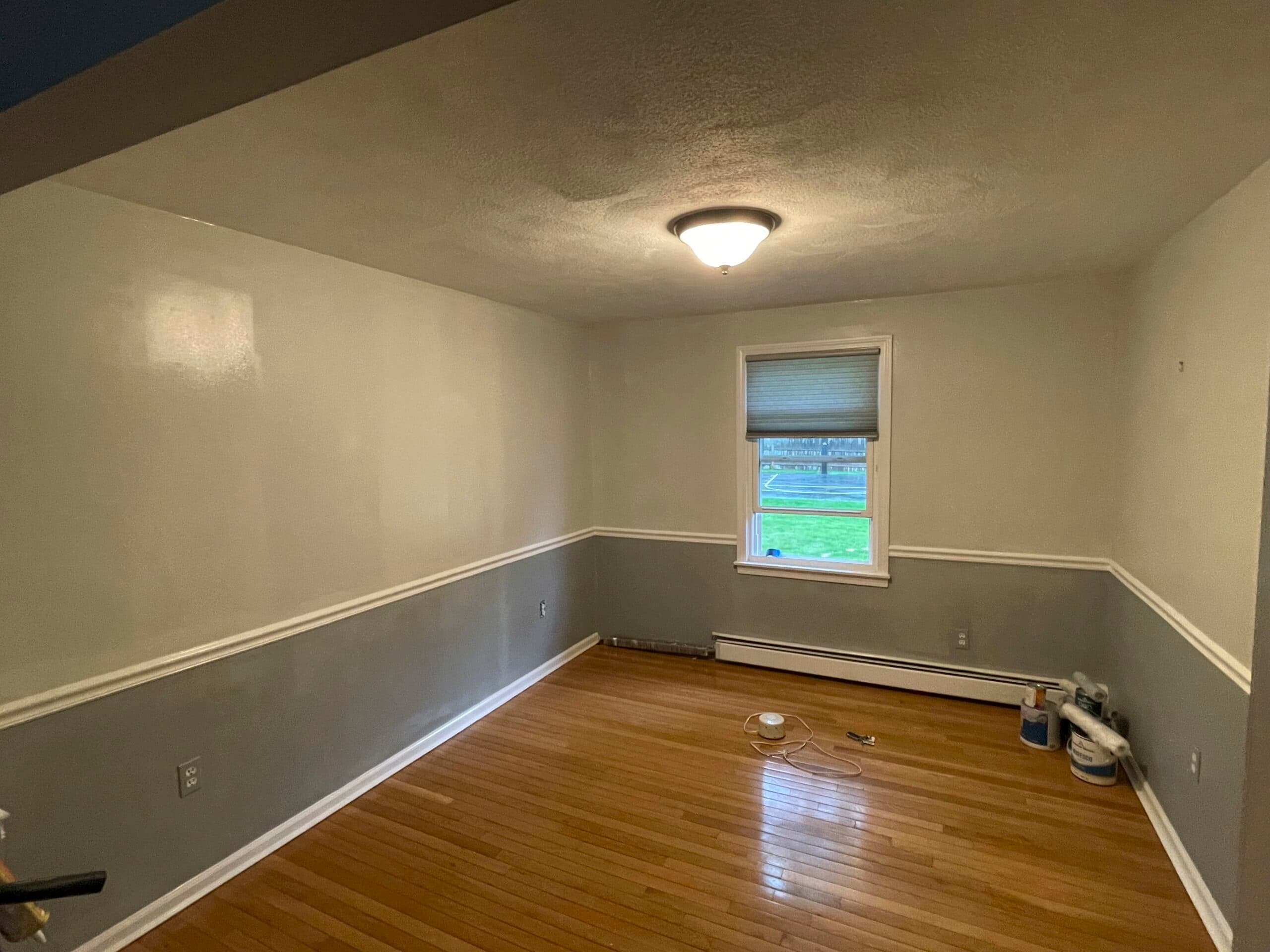 Freshly painted two-tone interior with a white chair rail, gray below and bright walls above