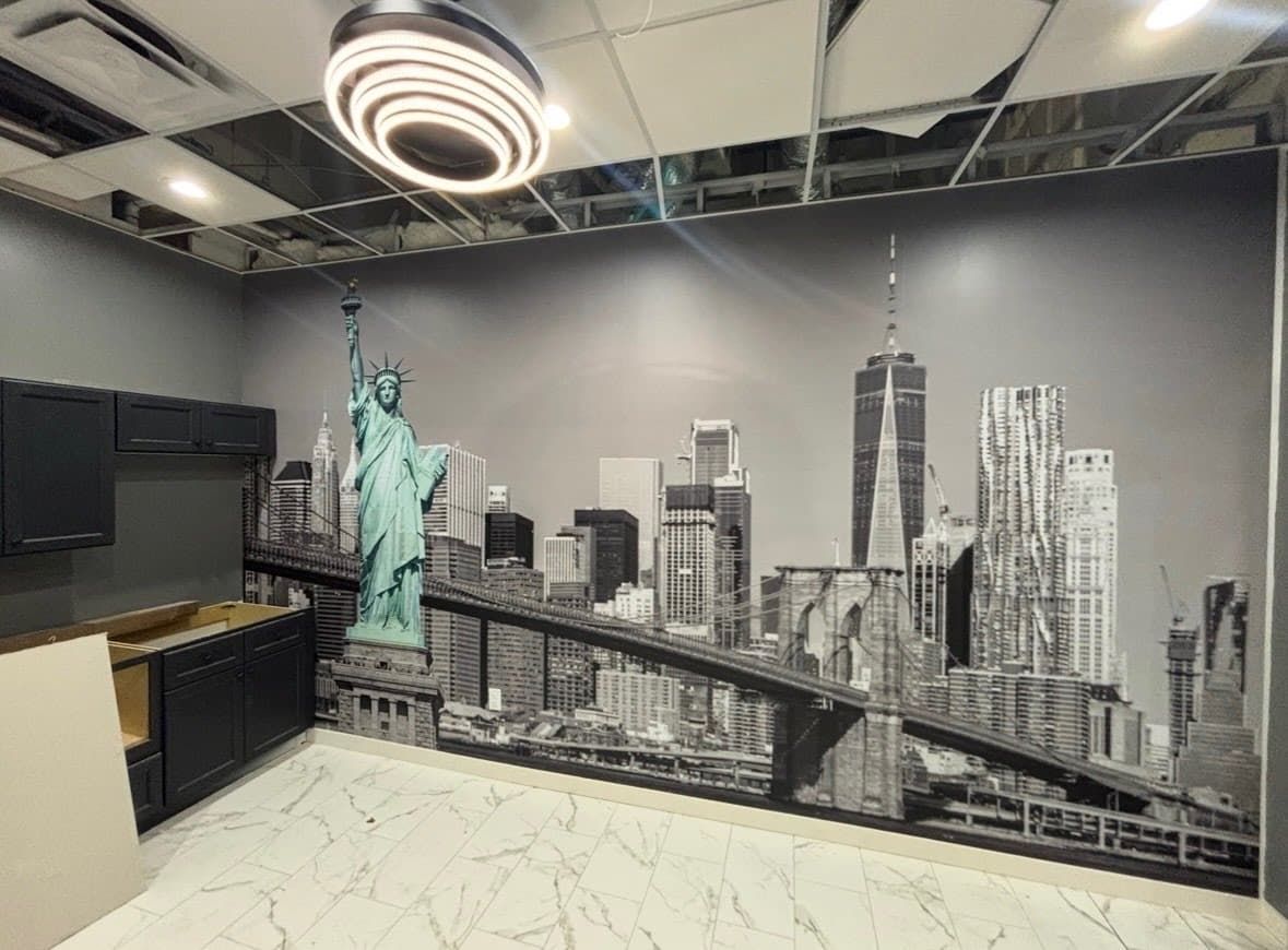 City skyline mural wallpaper installed on a commercial office accent wall